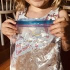 A child holds up a Bean Buddy activity