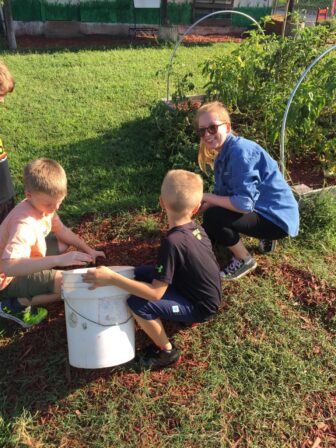 Tara working with kids in the garden