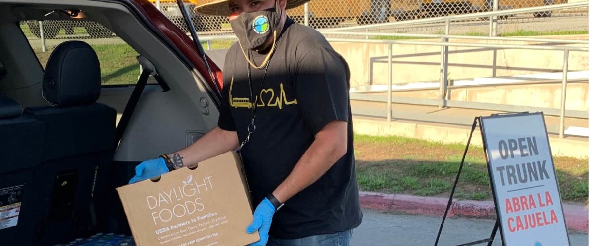 Person loading a box of food into a car