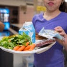 Child holding a lunch tray