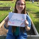 Katie Keith holds up a sign that reads "I'm rooting for you"