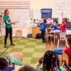 Emily Reckard teaching a lesson to kids in a classroom