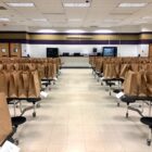 Rows of tables hold paper bags filled with food items