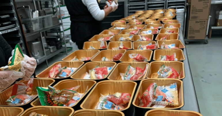 School nutrition workers prepare meals for students during the pandemic